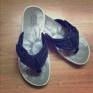Clark’s black and white flip flops. Size 5 M.